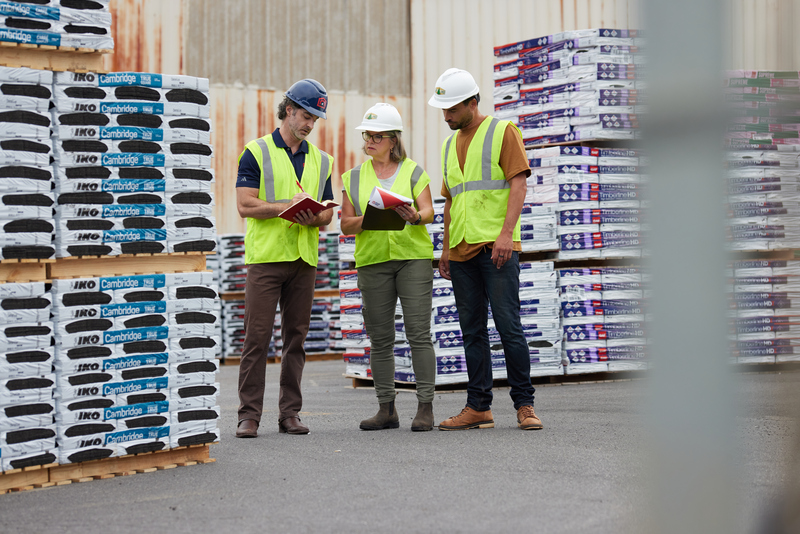 three people in lumber yard
